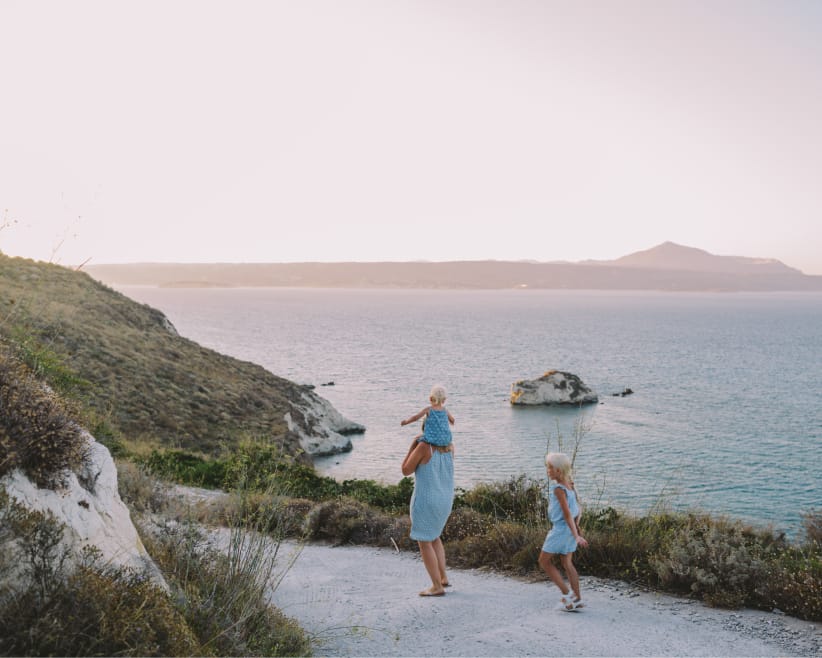 family walking along coast